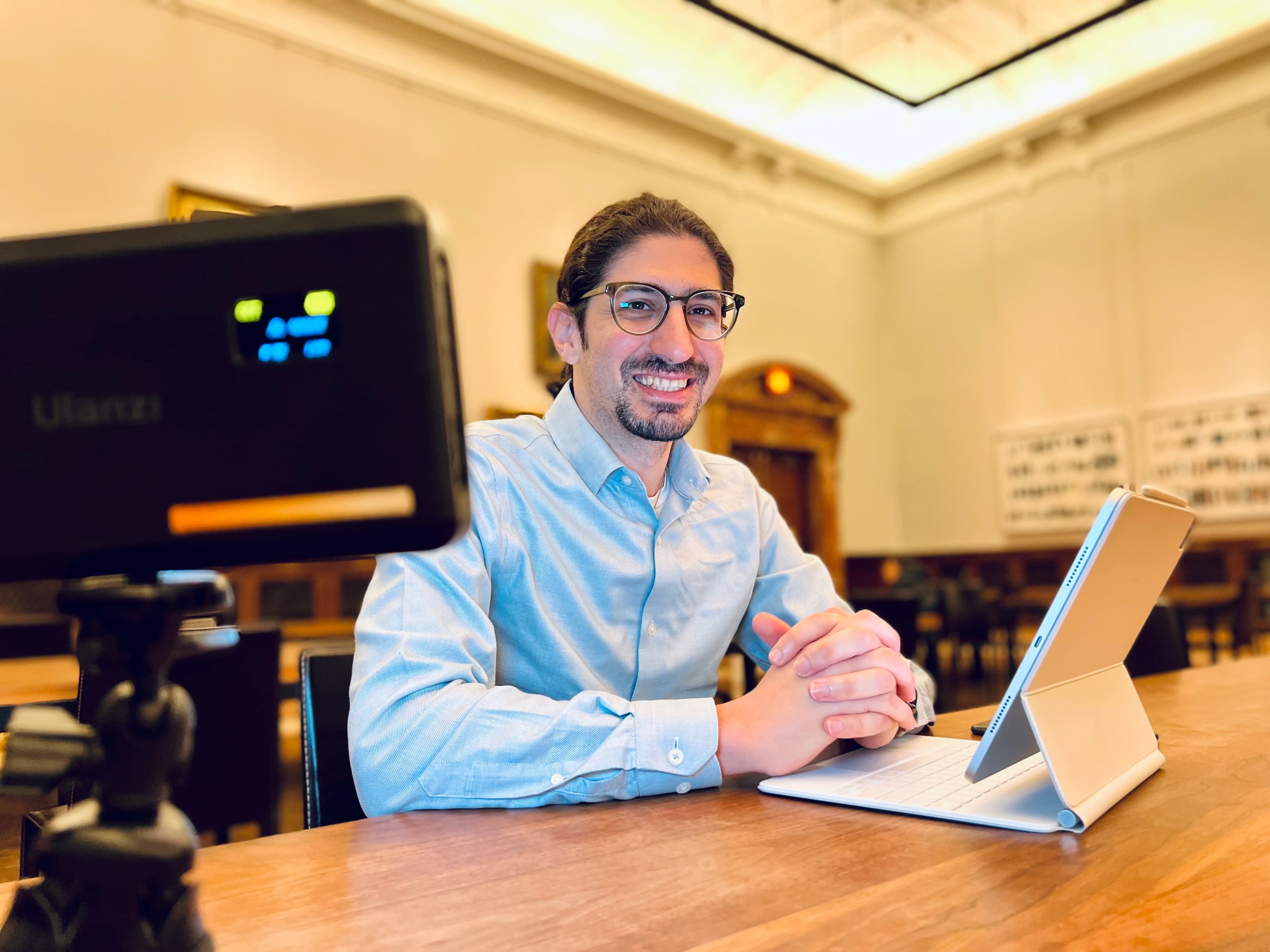 Carlo Mahfouz at a laptop in a library reading room