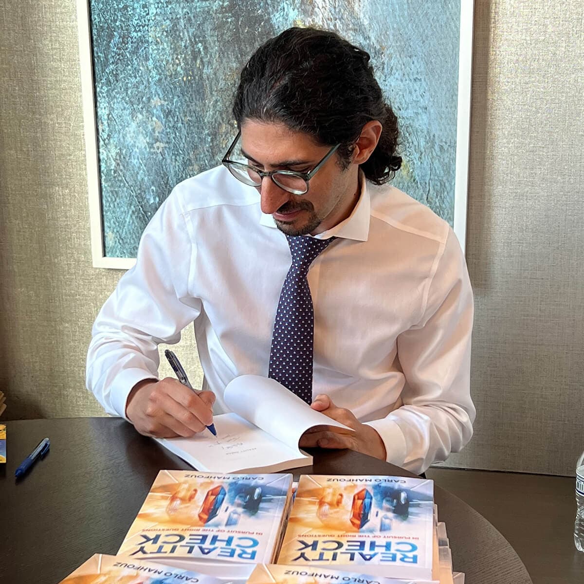 Carlo Mahfouz signing his book Reality Check